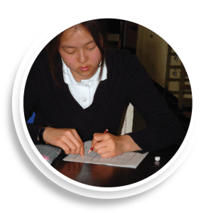 schoolgirl writing on paper